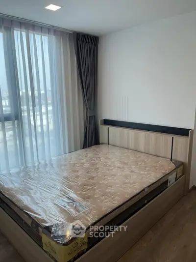Modern bedroom with large window and stylish bed in a bright apartment