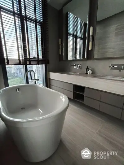 Luxurious bathroom with freestanding bathtub and city view