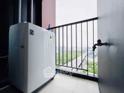 High-rise balcony with washing machine and city skyline view