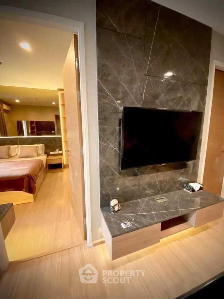 Modern bedroom with sleek TV setup and elegant decor