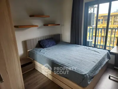 Cozy bedroom with modern design and ample natural light from large window