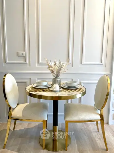 Elegant dining area with gold accents and modern decor
