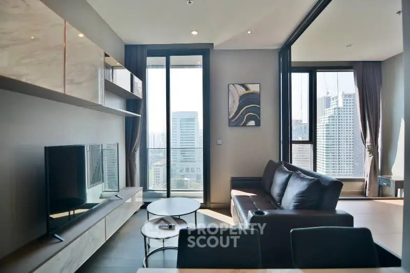 Modern living room with city view, sleek furniture, and large windows in a high-rise apartment.