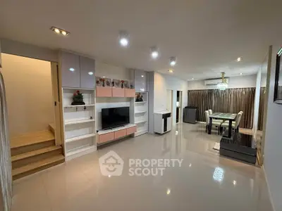 Spacious modern living room with sleek design and dining area, perfect for family gatherings.