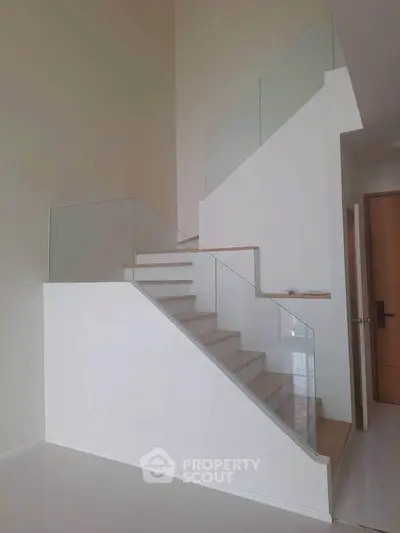 Modern staircase with glass railing in a contemporary home interior