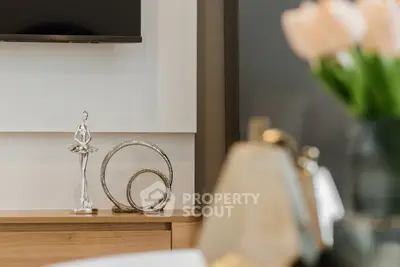 Elegant living room decor with modern art and stylish furnishings.