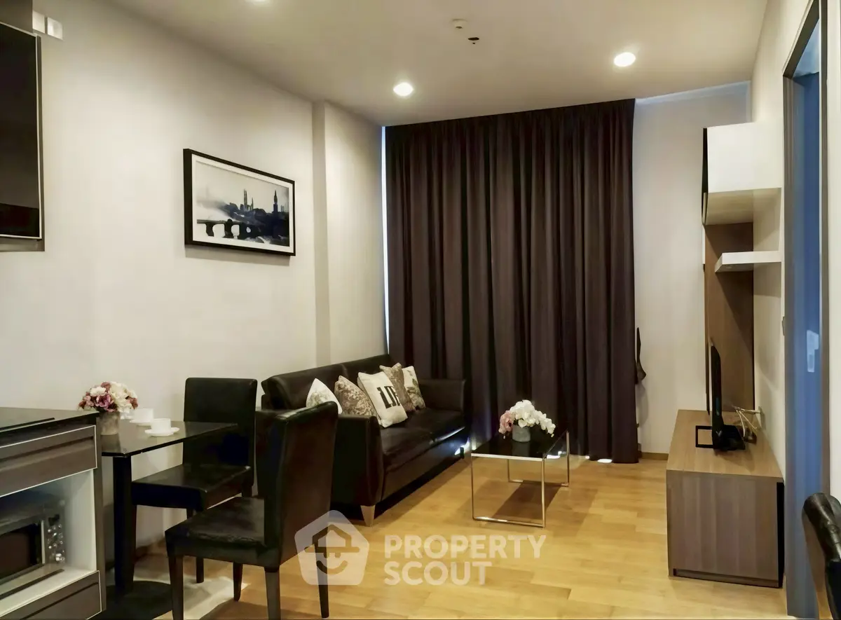 Modern living room with sleek furniture and wooden flooring in a cozy apartment.