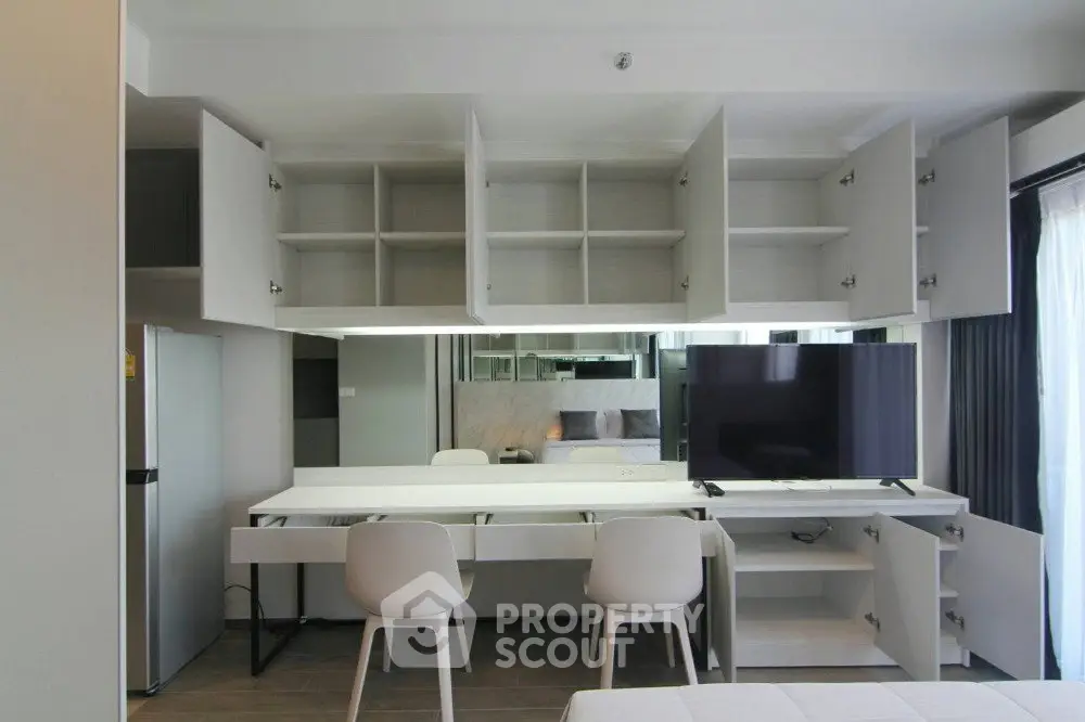 Modern apartment interior with open shelving and sleek furniture design