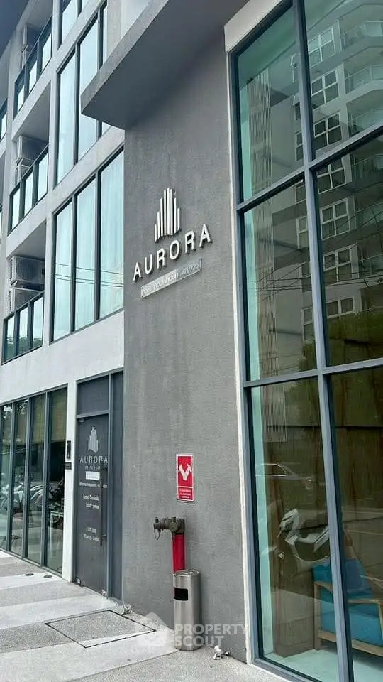 Modern building exterior with large glass windows and sleek design.