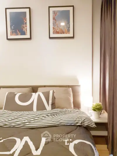 Cozy bedroom with modern decor and framed artwork above the bed