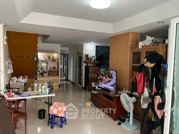 Spacious living room with modern decor and ample natural light