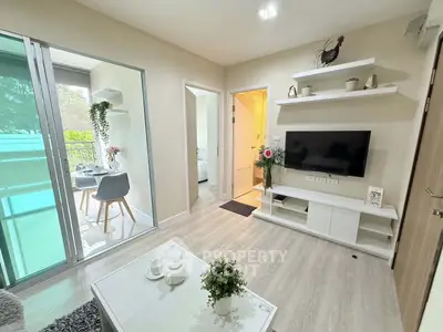 Modern living room with balcony access and stylish decor in a bright apartment.