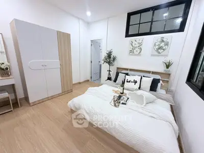 Modern bedroom with stylish decor and cozy ambiance, featuring a comfortable bed and elegant furnishings.