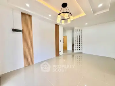 Spacious modern living room with elegant lighting and sleek tile flooring
