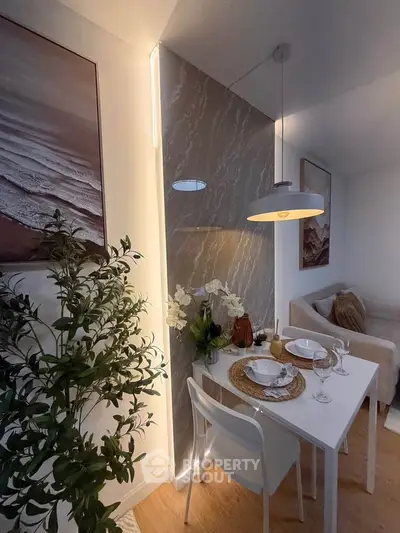 Chic dining area with modern decor and cozy seating in stylish apartment.