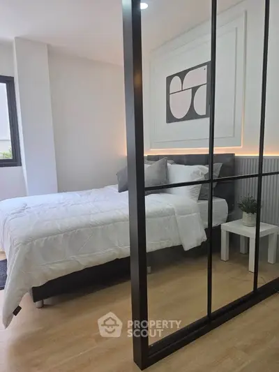 Modern bedroom with stylish decor and large window for natural light