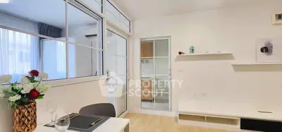 Modern living room with elegant decor and glass partition in stylish apartment.