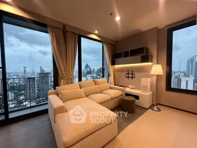 Luxurious living room with panoramic city view and elegant furnishings in high-rise apartment.