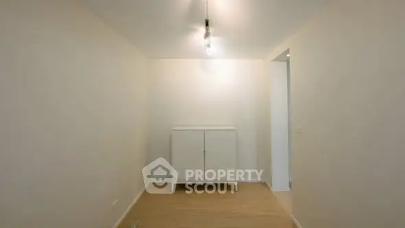 Minimalist interior with white cabinet and modern lighting