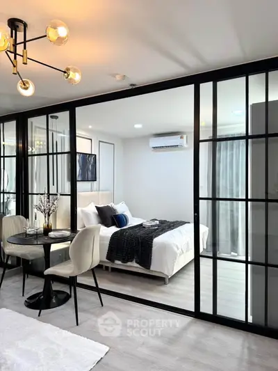 Modern apartment with glass partition, cozy bedroom, and elegant dining area.