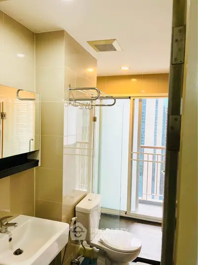 Modern bathroom with balcony view in urban apartment
