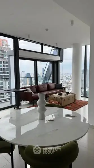 Luxurious modern living room with panoramic city views and elegant furnishings.