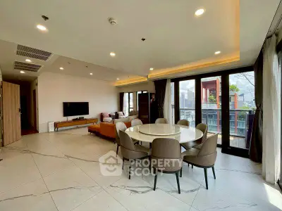 Spacious modern living room with large windows and city view, featuring elegant dining area and stylish decor.