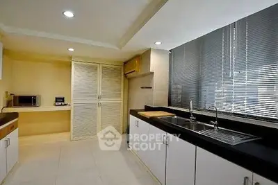 Spacious modern kitchen with sleek design and ample natural light.