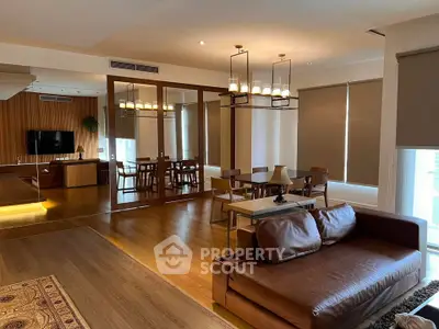 Spacious modern living room with elegant wooden flooring and stylish furniture