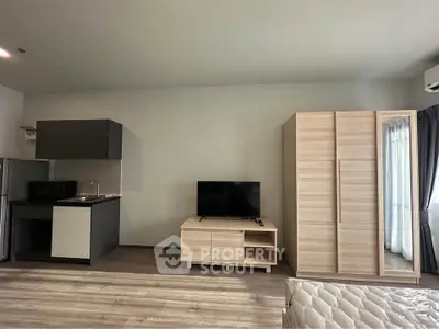 Modern studio apartment with sleek kitchen and cozy living area