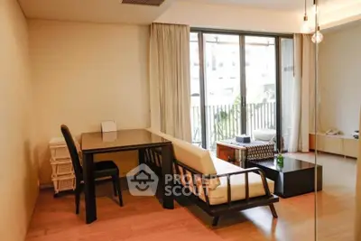 Spacious living room with modern furniture and large windows opening to a balcony.