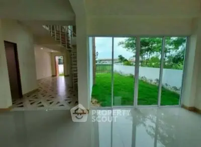 Spacious interior with large windows overlooking lush garden