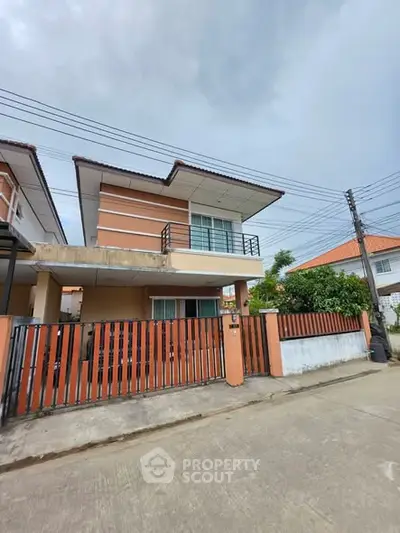 Charming two-story house with modern design and gated entrance in a serene neighborhood.