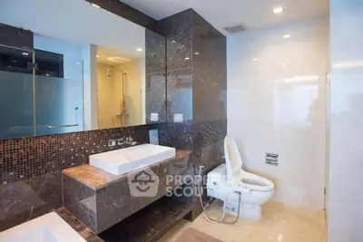 Luxurious modern bathroom with elegant marble finishes and spacious layout.