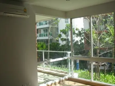 Bright corner unit with large windows and lush garden view, perfect for natural light lovers.