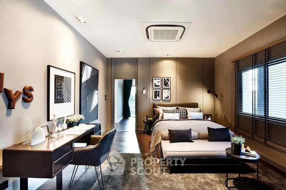 Luxurious modern bedroom with stylish decor and ample natural light.