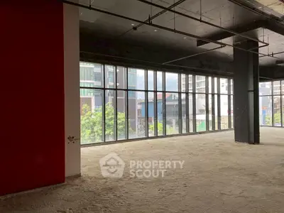 Spacious commercial space with large windows offering city views, ideal for modern office setup.