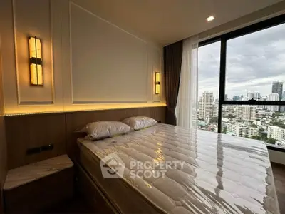 Luxurious bedroom with stunning city view and elegant lighting in modern high-rise apartment.