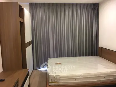 Modern bedroom with sleek wooden furniture and large window curtains