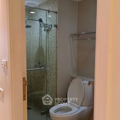 Modern bathroom with glass shower and sleek toilet design