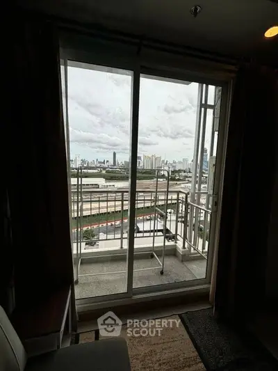 Stunning city view from a cozy apartment balcony with sliding glass doors.