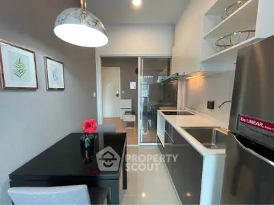 Modern kitchen with sleek design, featuring stainless steel appliances and elegant dining area.