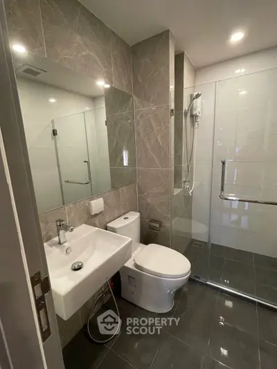 Modern bathroom with sleek fixtures and glass shower enclosure