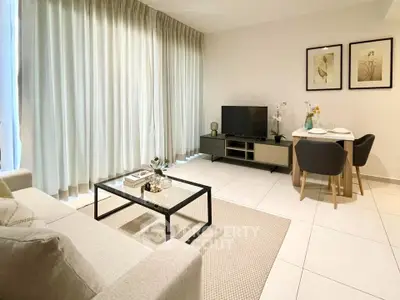 Modern living room with elegant decor and natural light, featuring a cozy seating area and stylish dining setup.