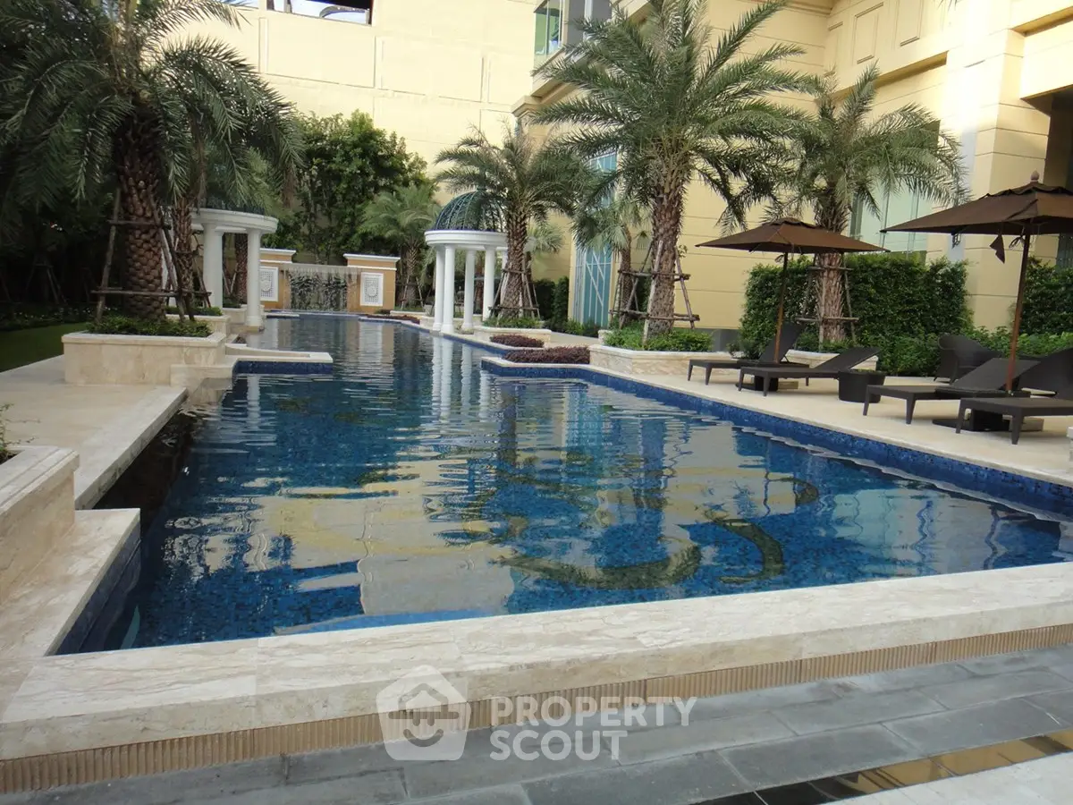 Luxurious outdoor pool area with elegant design and lush greenery, perfect for relaxation and leisure.