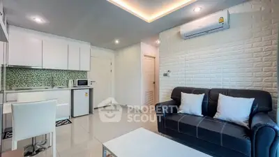 Modern open-plan living room with sleek kitchen and cozy seating area