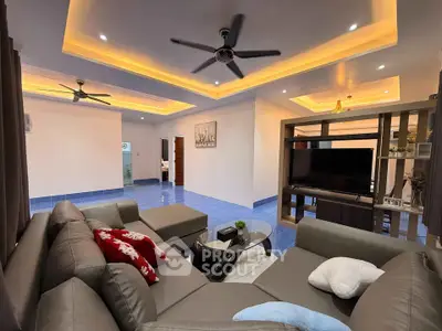 Spacious living room with modern ceiling lights and cozy sectional sofa.