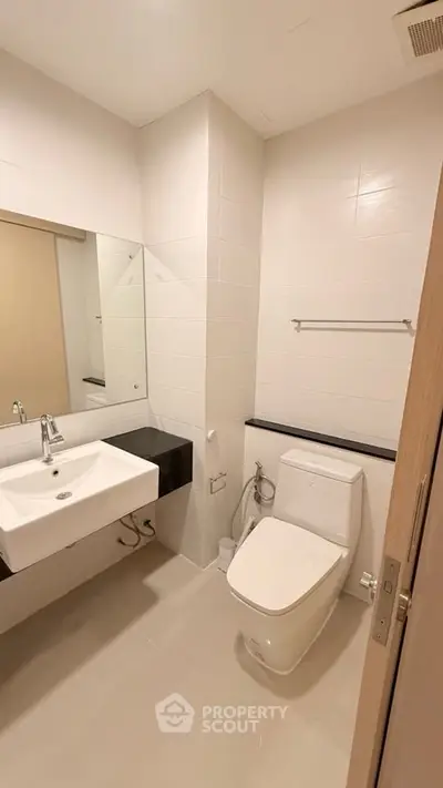 Modern bathroom with sleek fixtures and minimalist design in a contemporary apartment.
