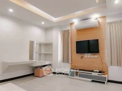 Modern living room with sleek TV setup and stylish lighting