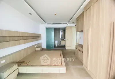 Spacious modern bedroom with built-in wooden furniture and sleek design